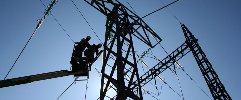 2 Commercial Electrical Contractors checking wires